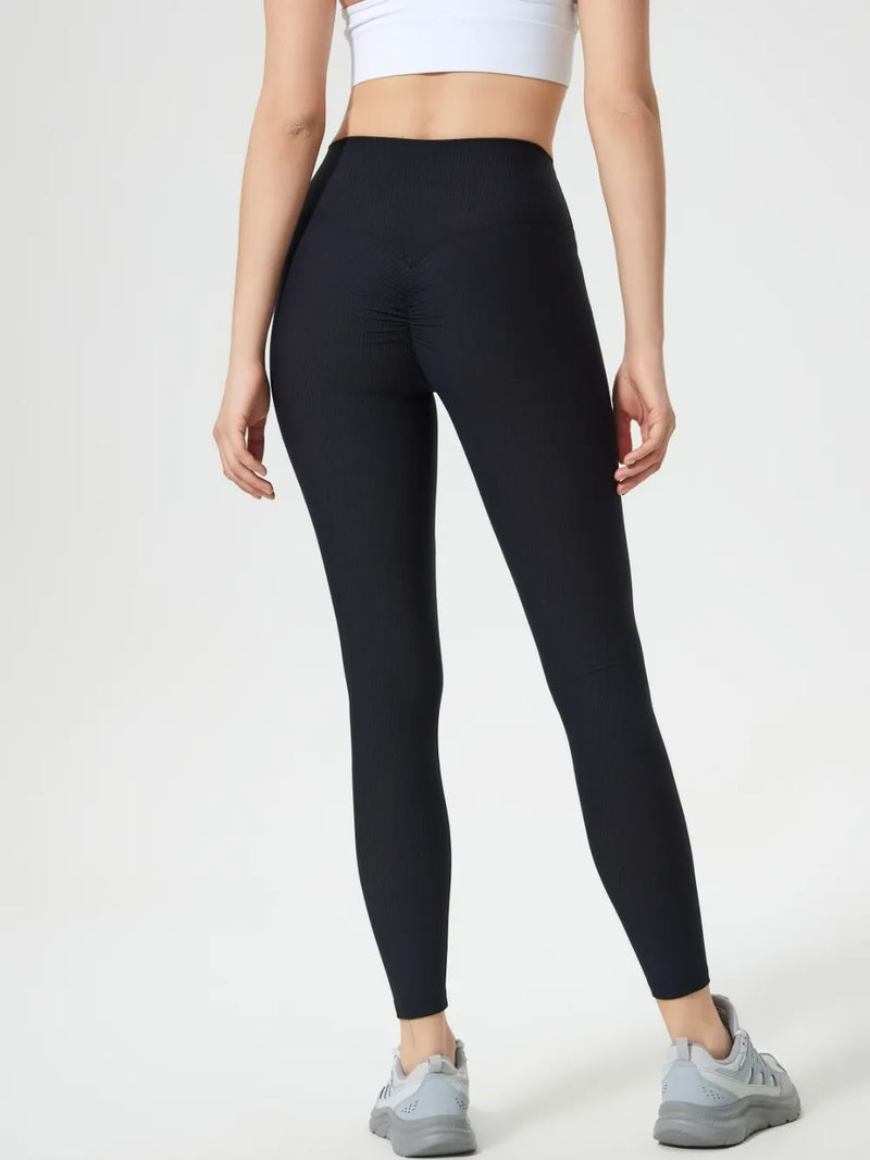 High Waisted Gym Leggings for Women with Scrunch Bum and Ribbed Texture in Black, three-quarter back view