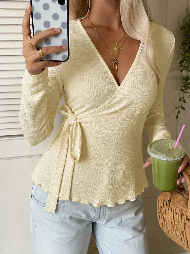 Long Sleeve Wrap Top for Women with Side Tie and Lettuce Edge Hem in Light Yellow, styled front view
