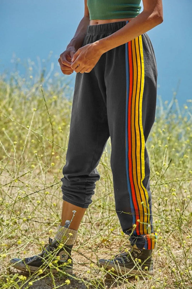 Side Stripe Track Pants for Women with Elastic Waist and Cuffed Ankles in Gray, side view outdoors