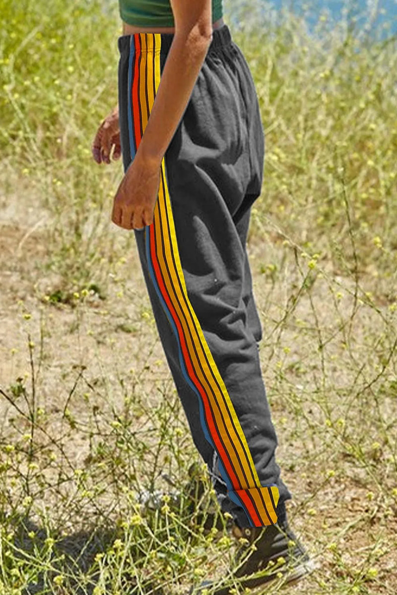 Side Stripe Track Pants for Women with Elastic Waist and Cuffed Ankles in Gray, walking side view