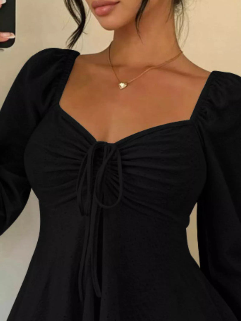 Long Sleeve Tie Front Top for Women with Sweetheart Neck and Peplum Hem in Black, close-up