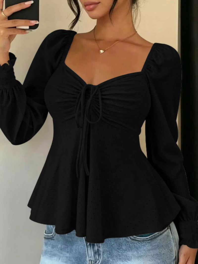 Long Sleeve Tie Front Top for Women with Sweetheart Neck and Peplum Hem in Black, front view
