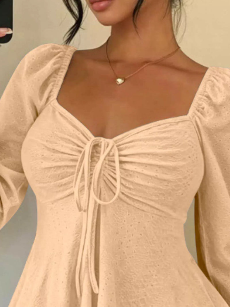Long Sleeve Tie Front Top for Women with Sweetheart Neck and Peplum Hem in Peach, close-up