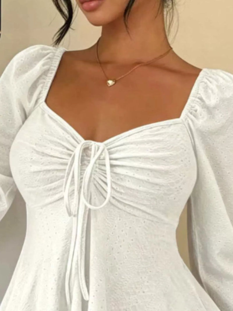 Long Sleeve Tie Front Top for Women with Sweetheart Neck and Peplum Hem in White, close-up